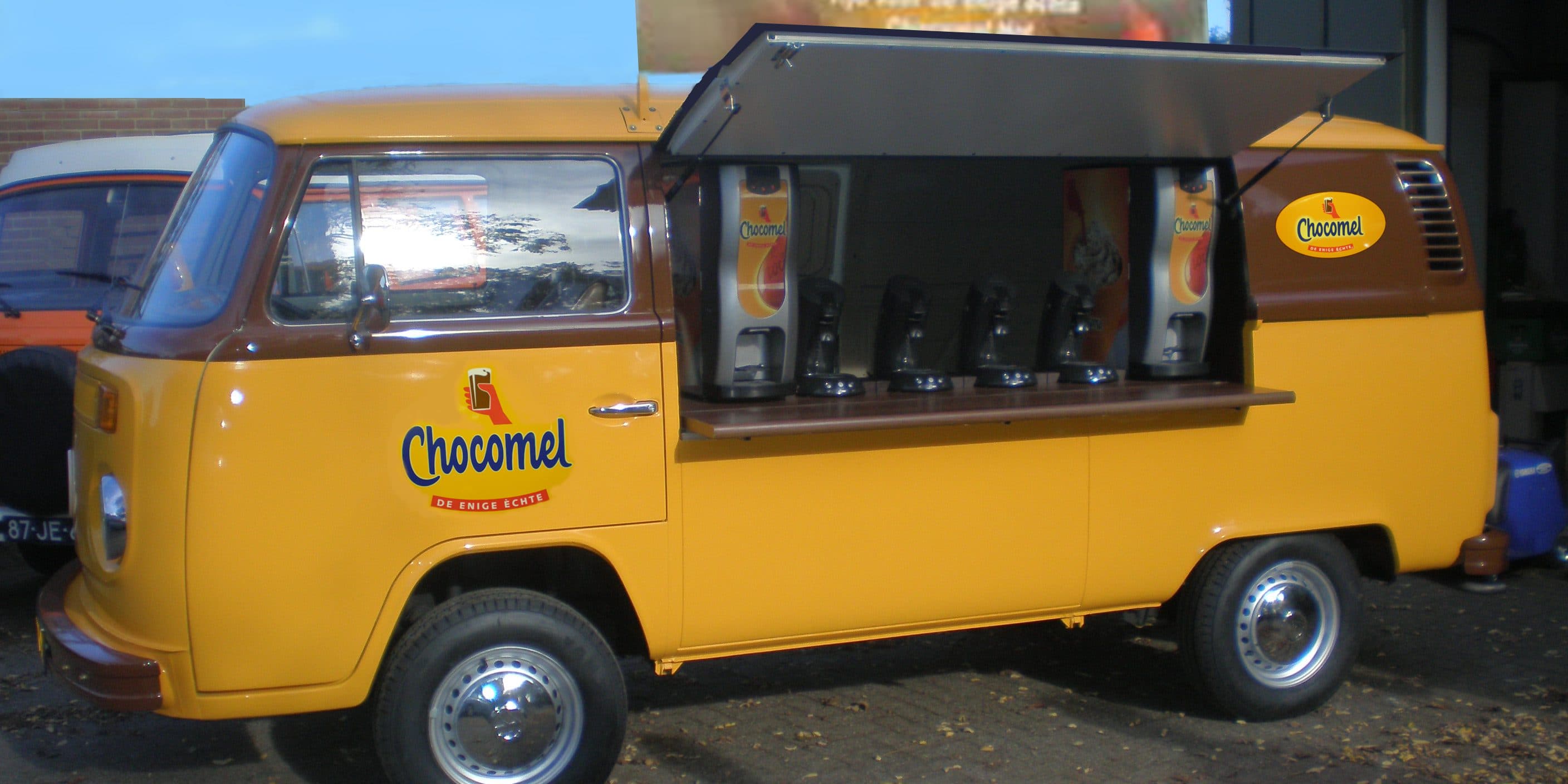 Mustard yellow VW T2 branded Chocomel food truck with dispensing machines inside
